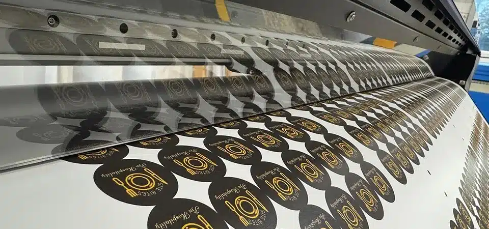 A large-scale, industrial sticker printing machine in operation